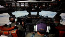 This picture taken on March 24, 2014 shows crew members on board an RAAF AP-3C Orion whilst transiting at high altitude on what was to be an 11 hour search mission for missing Malaysia Airways flight MH370 over the Indian Ocean. The air and sea search for Malaysia Airlines flight MH370 that crashed in the Indian Ocean was suspended on March 25 due to gale force winds, rain and big waves, the Australian Maritime Safety Authority said. AFP PHOTO / POOL / RICHARD WAINWRIGHT        (Photo credit should read RICHARD WAINWRIGHT/AFP/Getty Images)