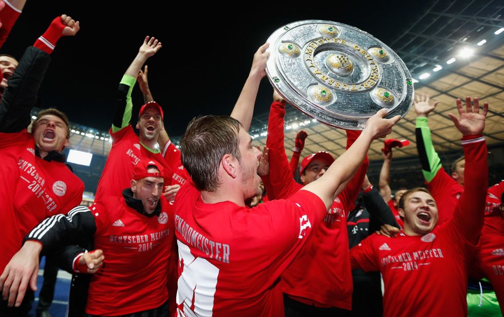 Bayern Munich's players celebrate with a replica of Bundesliga championship trophy after clinching the title at the Olympic Stadium in Berlin.