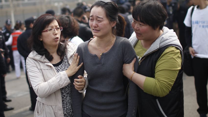 A relative of passengers on the missing Malaysia Airlines flight MH370 cries as she participates in a protest outside the Malaysian embassy in Beijing on March 25, 2014.
