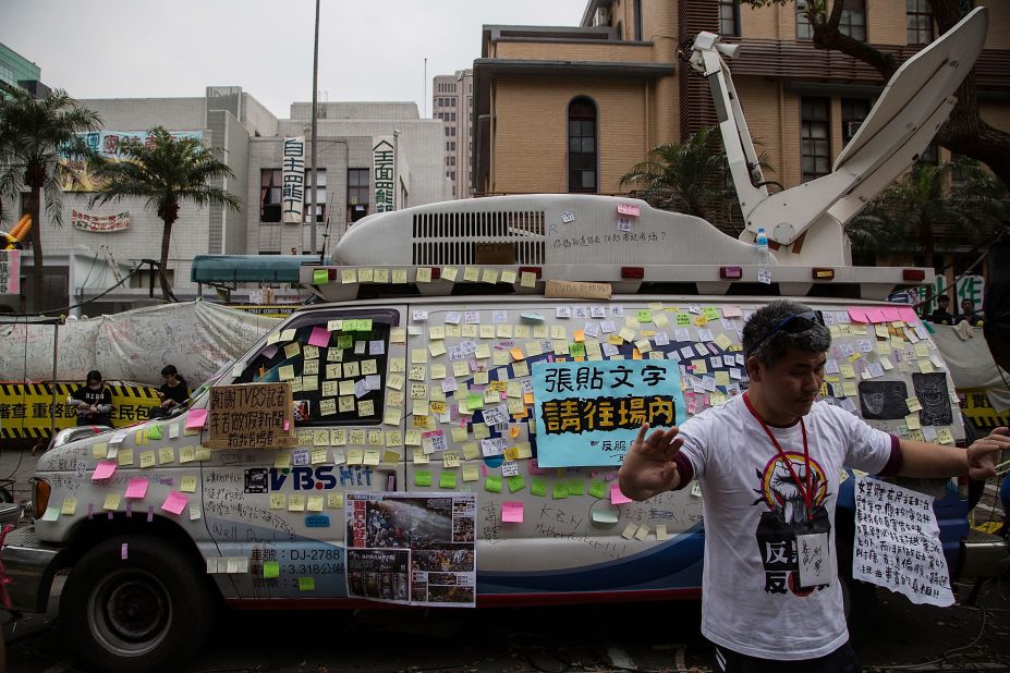 Anti-media slogans are posted on a TV station's van during a rally outside the Legislature on Monday, March 24.