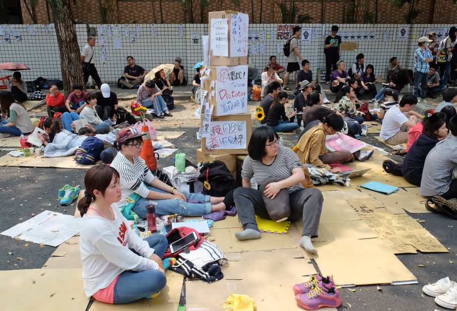 Protesters who oppose the trade agreement sit outside the Legislature during a demonstration in Taipei on Wednesday, March 26.