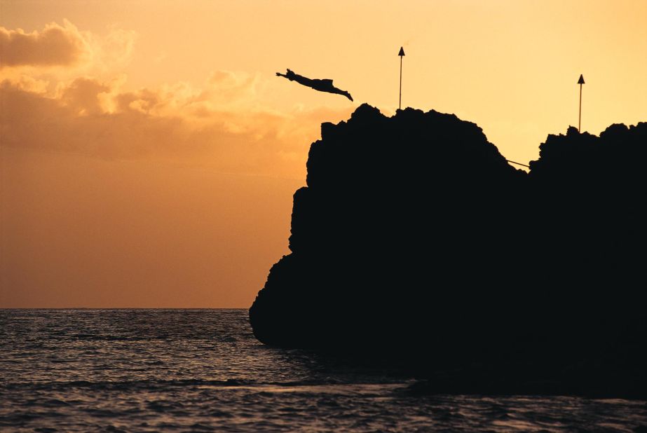 At the Sheraton Maui Resort & Spa, a diver celebrates the Hawaiian tradition of Lele Kawa, or cliff jumping.