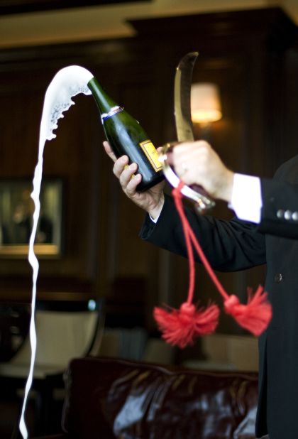 A saber is used to slice open champagne each evening at the St. Regis in Atlanta.