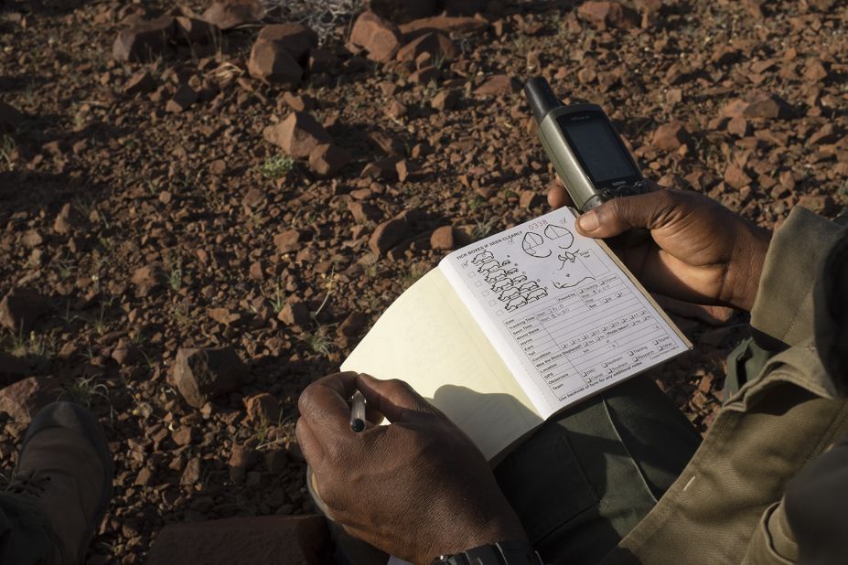 The guide records the GPS position in his logbook. It's been a good day. Rangers in Damaraland are proud of their job and the community looks up to them. 