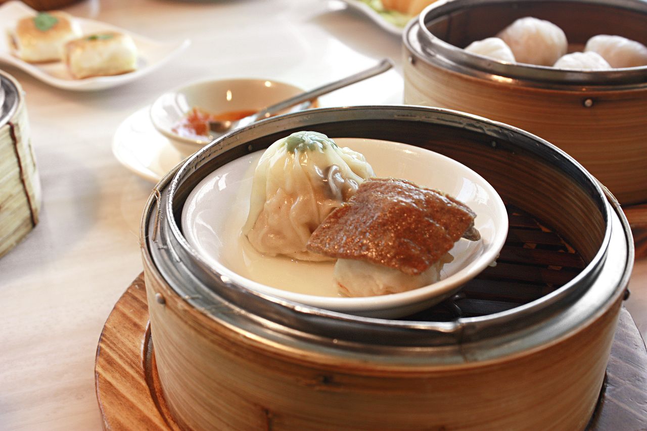 Two pieces of siu mai -- one with quail egg one with liver.