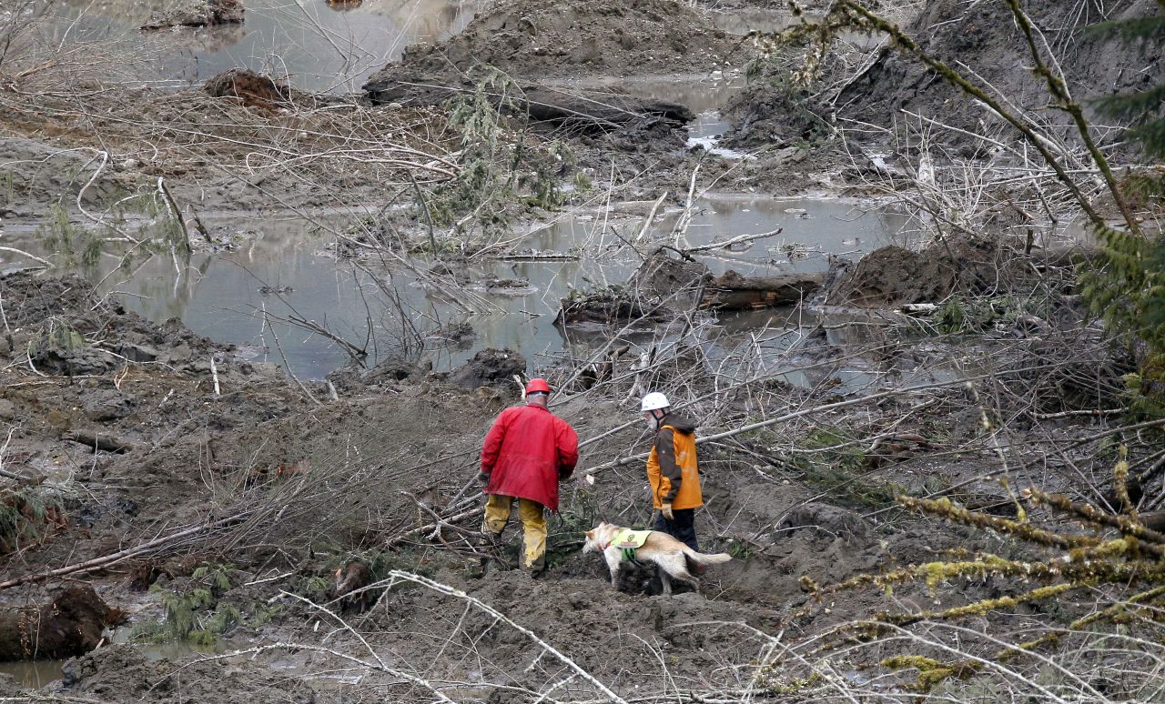 Search-and-rescue workers look through debris on March 26.