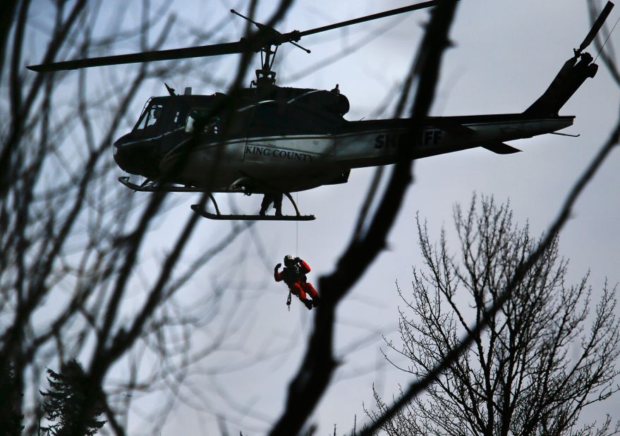A King County Sheriff's Office helicopter lowers a rescue worker on March 24.
