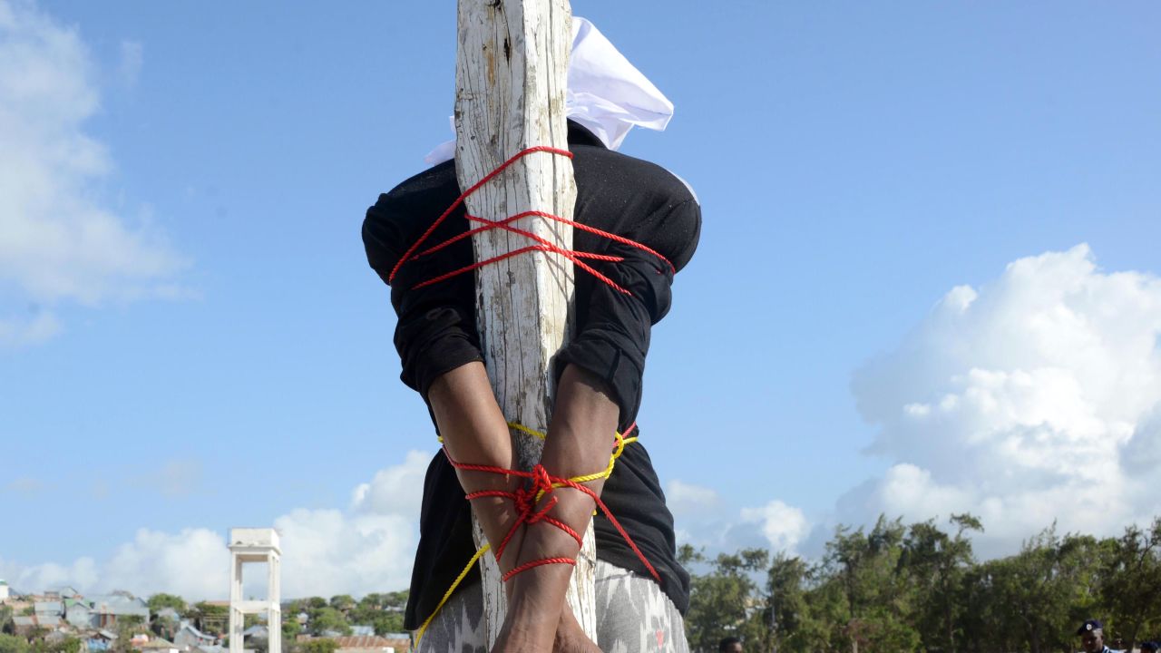 Convicted murderer Adan Sheikh Abdi is tied to a post before being executed by firing squad in August, 2013 in Somalia.