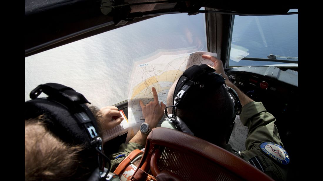 Flight Lt. Jayson Nichols looks at a map aboard a Royal Australian Air Force aircraft during a search on March 27, 2014.