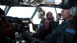 Flying Officer Stuart Doubleday, left, and Warrant Officer Michael Makin are in the cockpit of a Royal Australian Air Force AP-3C Orion aircraft during a search operation of the missing Malaysian Airlines flight MH370 over the southern Indian Ocean, Thursday, March 27, 2014. Planes and ships searching for debris suspected of being from the downed Malaysia Airlines jetliner failed to find any Thursday before bad weather cut their hunt short in a setback that came as Thailand said its satellite had spotted even more suspect objects. (AP Photo/Michael Martina, Pool)