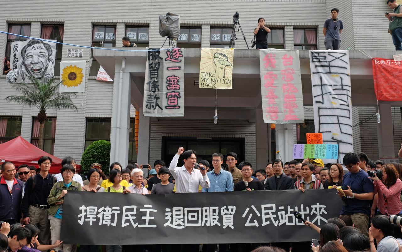 Protesters who oppose the trade agreement hold a rally outside Taiwan's Legislature on Thursday, March 27.