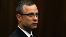 Oscar Pistorius sits in the dock during his trial for the murder of his girlfriend Reeva Steenkamp, at the North Gauteng High Court in Pretoria, on March 25, 2014.