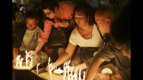 People in Kuala Lumpur light candles during a ceremony held for the missing flight's passengers on March 27, 2014.
