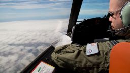 Flight Lieutenant Jayson Nichols looks out of the cockpit of a Royal Australian Air Force AP-3C Orion aircraft over cloud while searching for missing Malaysian Airlines flight MH370 over the southern Indian Ocean on March 27, 2014 off the coast of Perth, Australia.