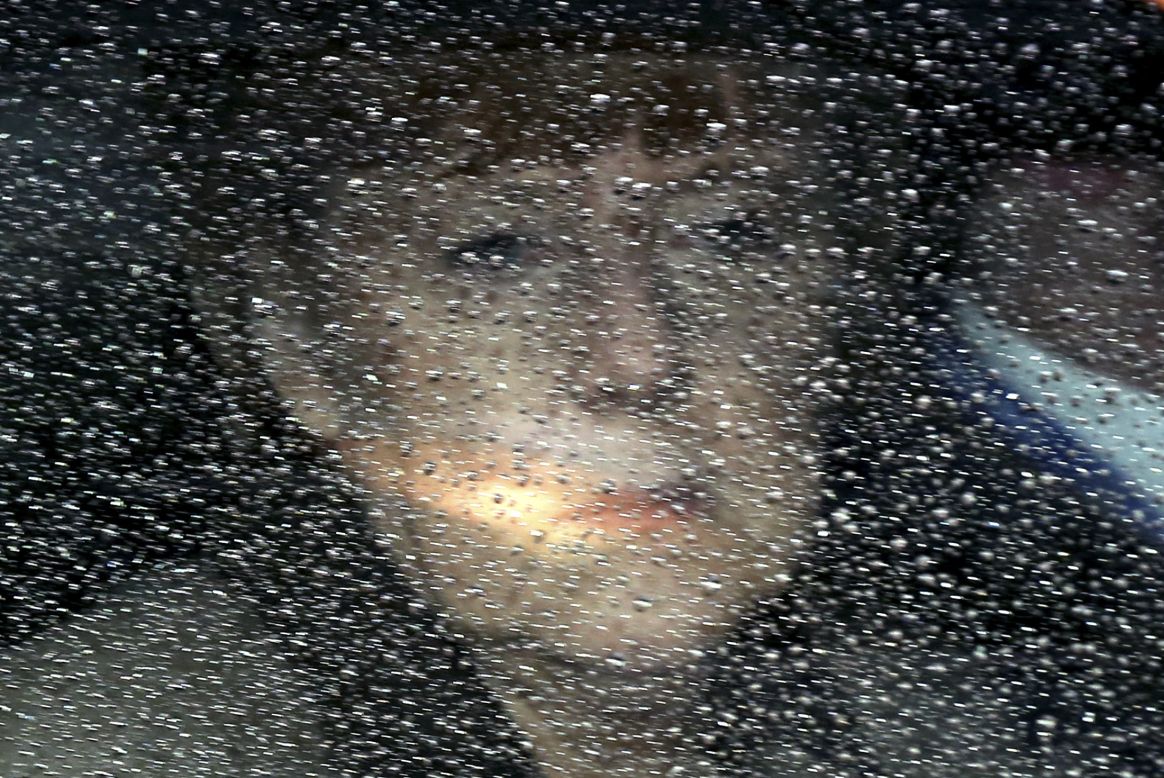German Chancellor Angela Merkel looks through her window as she arrives at a European Union summit in Brussels, Belgium, on Friday, March 21.