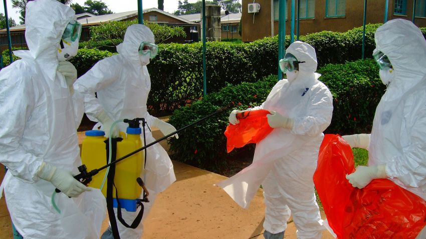 A picture taken on July 28, 2012 shows officials from the World Health Organization wearing protective gear as they prepare to enter Kagadi Hospital in Uganda's western Kibale district, around 200 kilometres (125 miles) from Kampala.