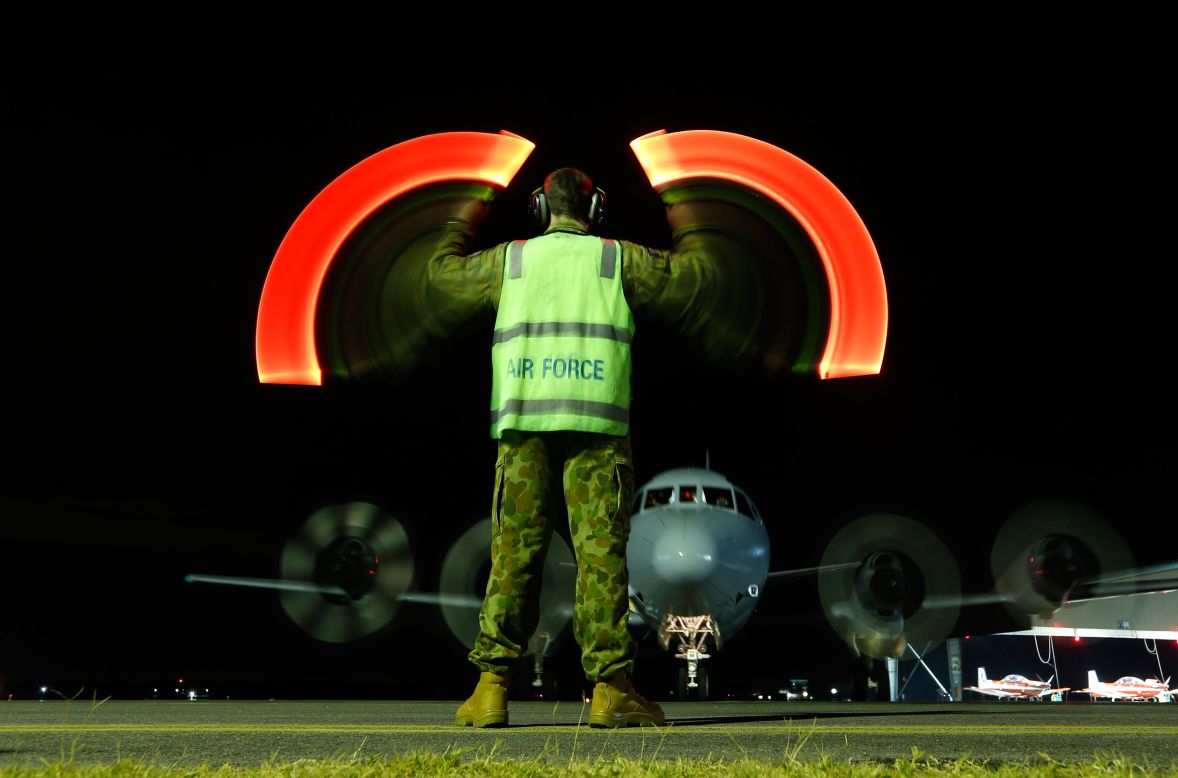 A plane with the Royal Australian Air Force returns to base in Bullsbrook, Australia, on Wednesday, March 26, after being used in <a href="http://www.cnn.com/2014/03/07/asia/gallery/malaysia-airliner/index.html">the search for Malaysia Airlines Flight 370</a>. A slow shutter speed was used to create the light effect in this photo.