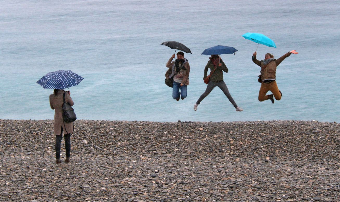 Tourists in Nice, France, jump for a photo in front of the Mediterranean Sea on Saturday, March 22.