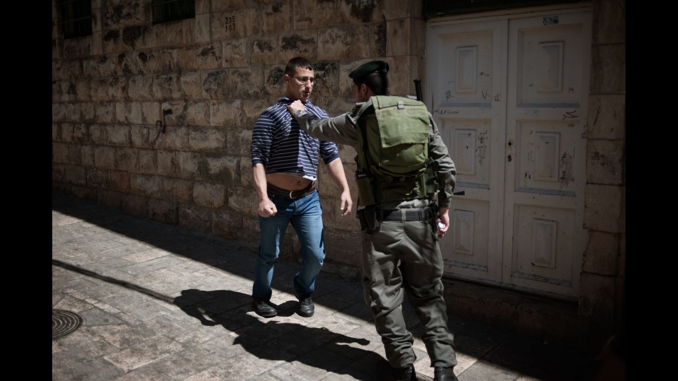 An Israeli soldier stops a young Muslim in front of the Al-Aqsa Mosque in Jerusalem on Friday, March 21.