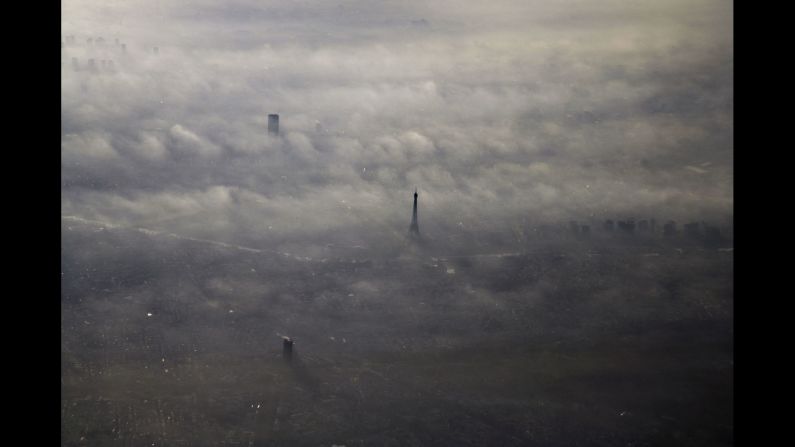 The Eiffel Tower peeks above the morning fog in 2005. 