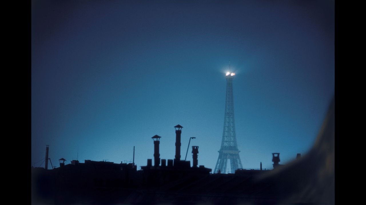 The Eiffel Tower is seen above Parisian rooftops in 1959.