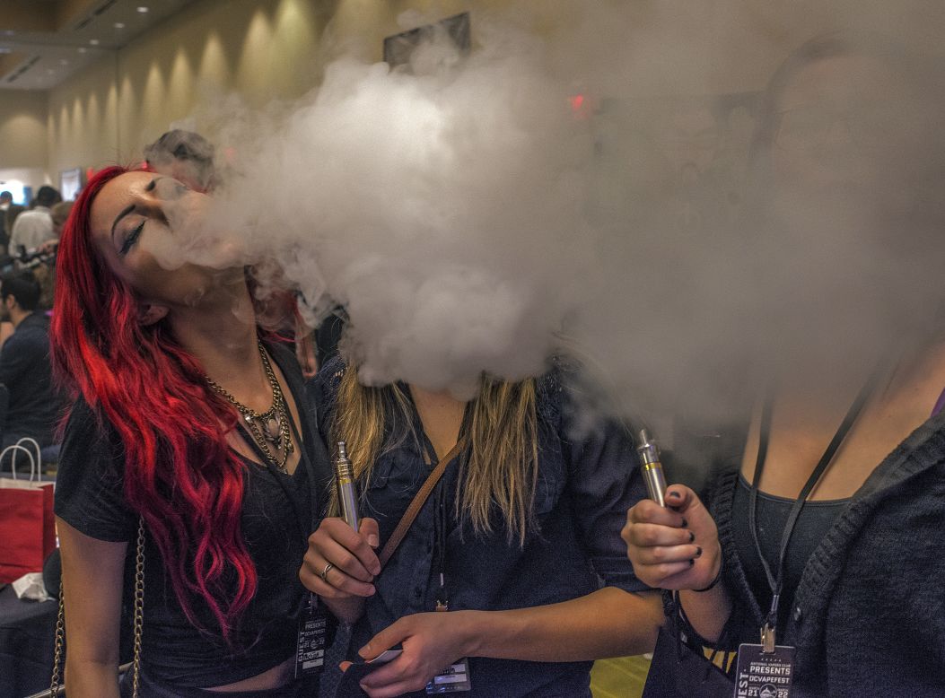 Melissa Sceranka, left, creates a smoke cloud at the Vapefest, which brings together users of electronic cigarettes and vapor delivery systems, on Friday, March 21, in Herndon, Virginia.