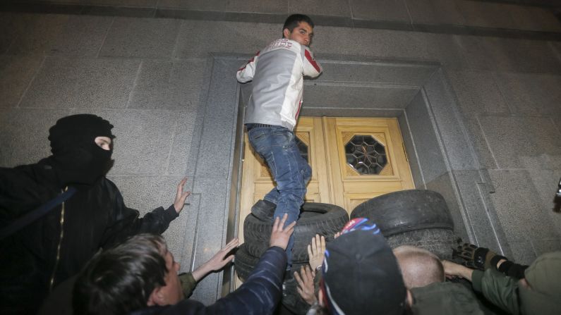 Members of the Right Sector group block the Ukrainian parliament building in Kiev on Thursday, March 27. Activists called for Interior Minister Arsen Avakov to step down after the <a href="index.php?page=&url=http%3A%2F%2Fwww.cnn.com%2F2014%2F03%2F26%2Fworld%2Feurope%2Fukraine-right-wing%2Findex.html">recent killing of radical nationalist leader Oleksandr Muzychko</a>, who died during a police operation to detain him. Muzychko and the Right Sector are credited with playing a lead role in the protests that toppled Ukrainian President Victor Yanukovych.