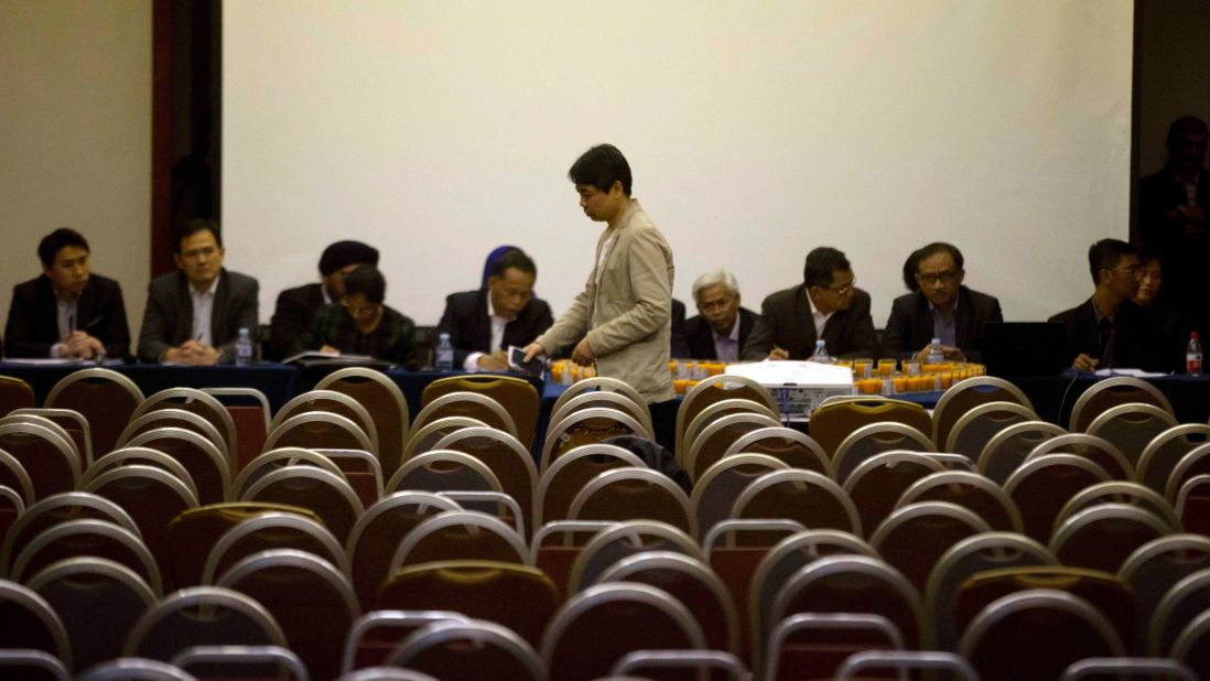 The sole representative for the families of Flight 370 passengers leaves a conference at a Beijing hotel on March 28, 2014, after other relatives left en masse to protest the Malaysian government's response to their questions.