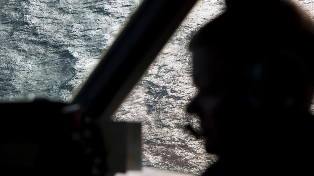 A member of the Royal Australian Air Force is silhouetted against the southern Indian Ocean during the search for the missing jet on March 27, 2014.