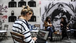 A woman uses a laptop computer showing Youtube's logo on March 27, 2014 in Istanbul, near a poster Berkin Elvan, the 15-year-old boy who died nine months after he was hit by a tear gas canister while going to buy bread during the 2013 protests in Istanbul. Turkey on March 27 banned video-sharing website YouTube, a week after blocking access to Twitter, after both were used to spread audio recordings implicating the prime minister in corruption, local media reported. AFP PHOTO / OZAN KOSE (Photo credit should read OZAN KOSE/AFP/Getty Images)