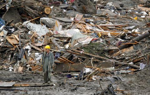 A searcher walks near a massive pile of debris in Oso on March 27.
