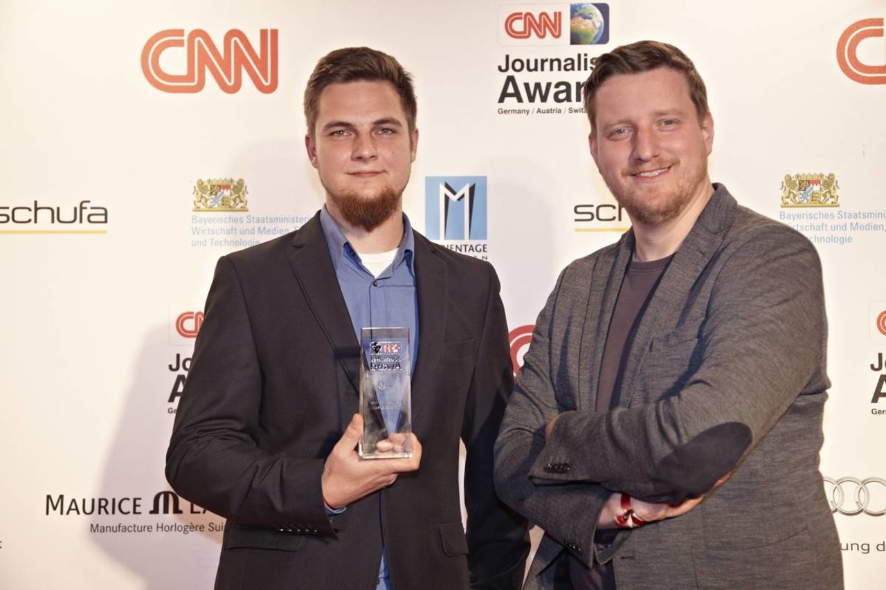 Christian Werner (pictured here on the left with judging panelist Stefan Ploechinger) celebrates following his win in the Online category for his work "On the Trail of Dead Children" presented on the Der Spiegel iPad app.