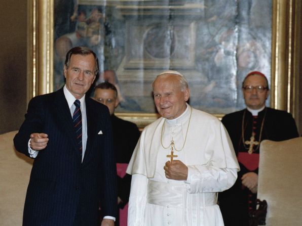May 27, 1989, President George H.W. Bush gestures while standing with Pope John Paul II in the papal library at the Vatican.
