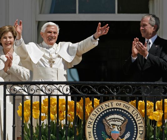 First lady Laura Bush and President George W. Bush applaud as Pope Benedict XVI waves to the crowd at the White House during an arrival ceremony on April 16, 2008.