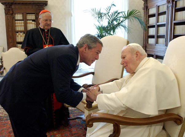 President George W. Bush shakes hands with Pope John Paul II upon his arrival for a private meeting at Vatican June 4, 2004.