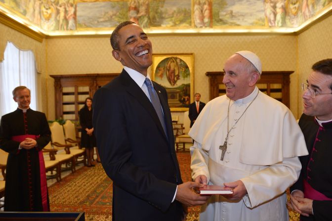President Barack Obama and Pope Francis exchange gifts during a private audience on March 27, 2014 at the Vatican.