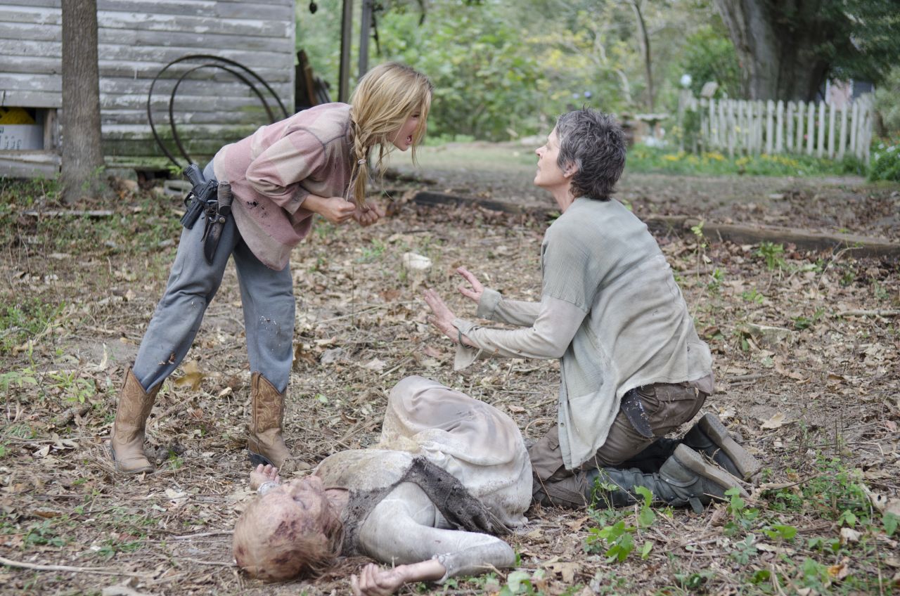 Among the most shocking deaths in the fourth season was that of young Lizzie (Brighton Sharbino, left), who died at the hands of Carol (Melissa McBride, right) after killing her younger sister, Mika. Lizzie's sense of right and wrong and life and death had been warped by the zombie apocalypse. Just as she did earlier in the season, Carol had to make the decision that someone was too dangerous to live. Carol urged Lizzie to follow her therapy of "look at the flowers" before she shot her in the back of the head.