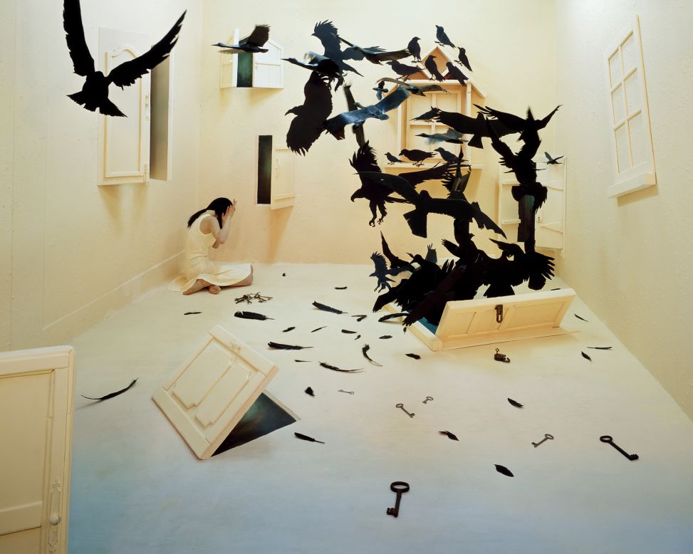 <em>Black birds</em><br /><br />Fears and negative feelings are represented as menacing crows bursting through a door in the floor, as a figure cowers in the corner of the room. "For me large birds are threatening, and the image of their feathers, beak, and curved talons is frightful," says Lee. The scene is fraught with turmoil, and the doors represent future changes and challenges that the artist will have to go through. <br /><br />Lee's images have a cathartic effect on her life, but reliving events that inspired them isn't always easy:" I have to think about it over and over again which can sometimes be very difficult" she says.  