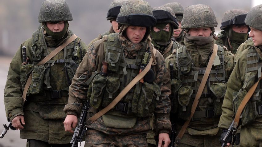 Russian soldiers patrol the area surrounding the Ukrainian military unit in Perevalnoye, outside Simferopol, on March 20, 2014.