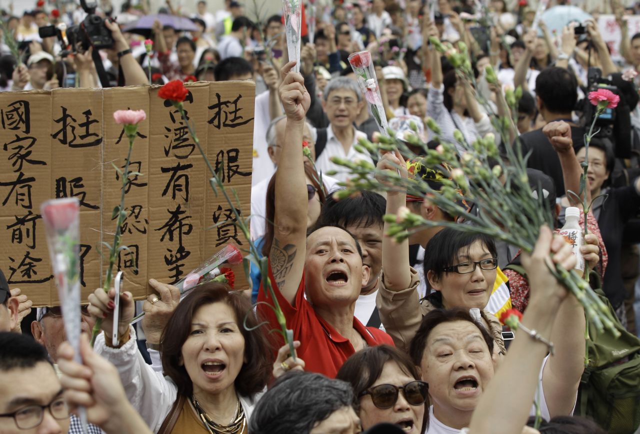 Demonstrators rally in Taipei on Saturday, March 29, asking students to retreat from the Legislature and return the government building to its normal working schedule.