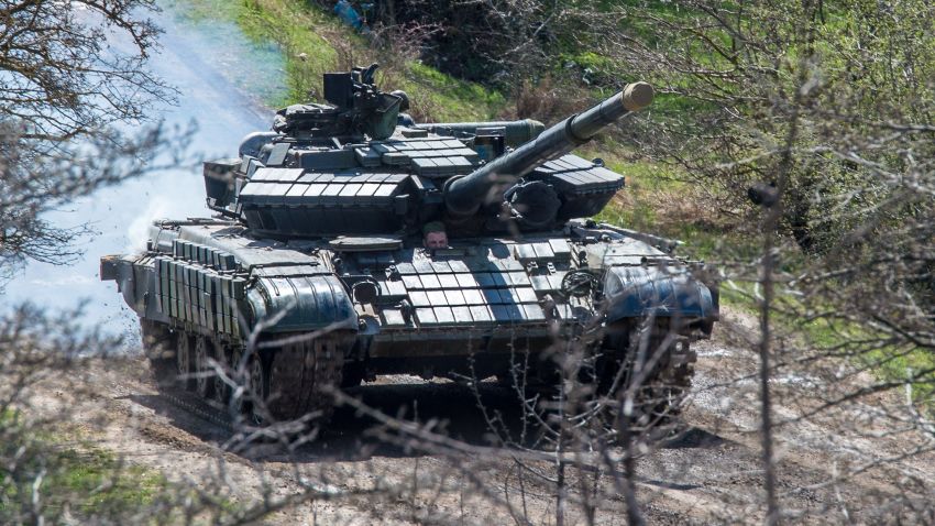 A Russian tank rolls outside a former Ukrainian military base in Perevalnoye, near the Crimean capital Simferopol, on March 27, 2014.