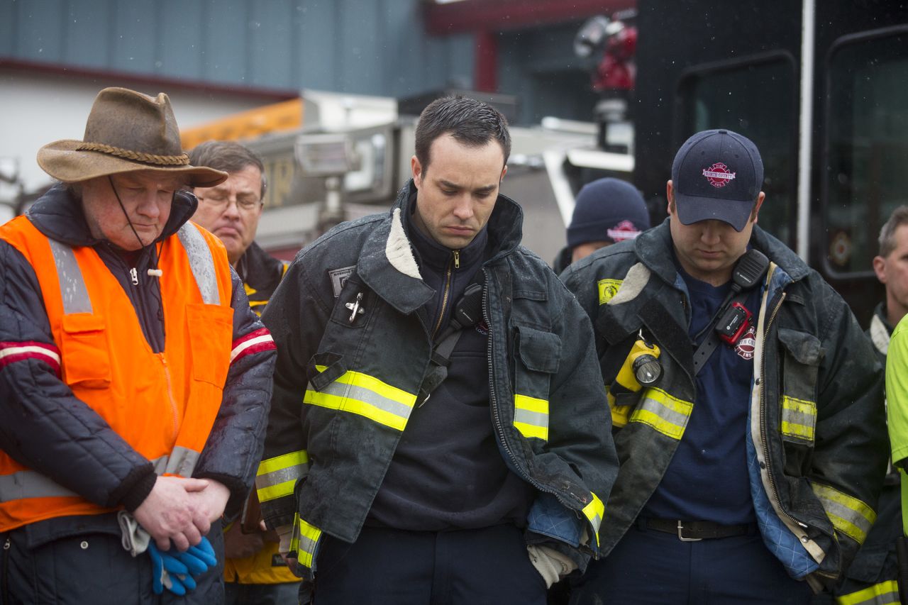 Search-and-rescue personnel attend a moment of silence at the fire house in Darrington.
