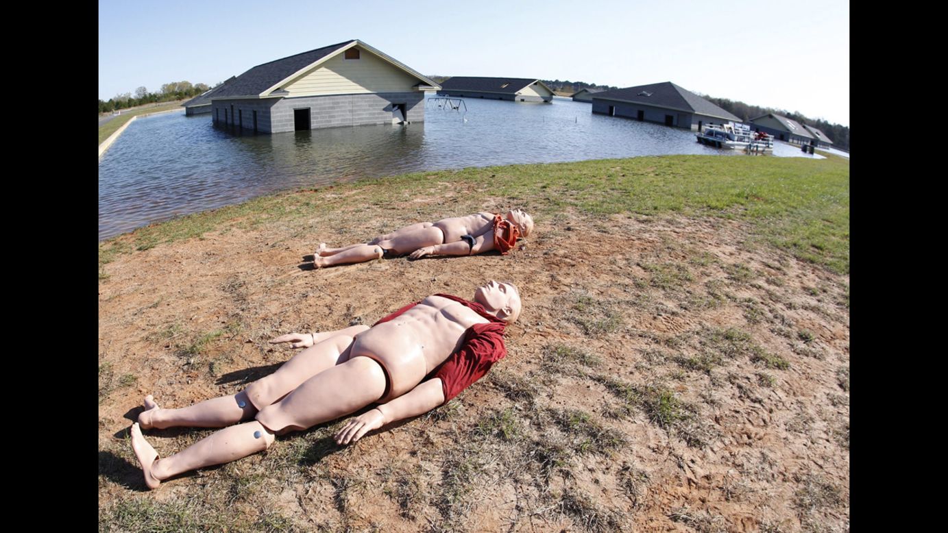 Dummy victims lie next to a flooded area that represents a flooding situation like that during Hurricane Katrina.