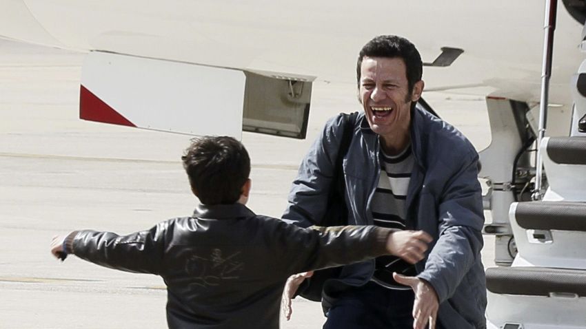 El Mundo correspondent Javier Espinosa is greeted by his son as he arrives at the military airbase in Torrejon de Ardoz, near Madrid, on March 30, 2014. Two Spanish journalists taken hostage in Syria by an Al-Qaeda-linked group walked free after six months in captivity