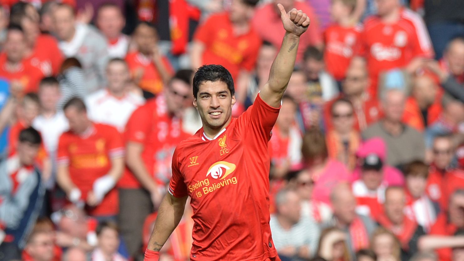 Luis Suarez acknowledges the Anfield crowd after scoring Liverpool's second goal against Spurs on Sunday. 