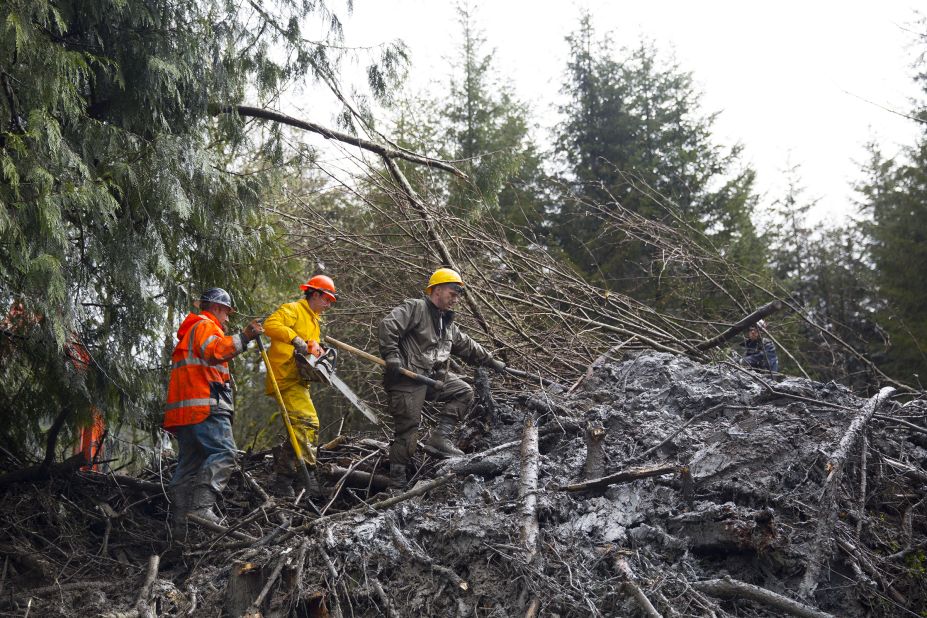 Rescue workers dig through mud and debris near Darrington, Washington, on Saturday, March 29. 