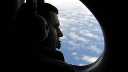 : 	IN FLIGHT - MARCH 29: Sergeant Peter Shomos looks out from a Royal Australian Airforce (RAAF) Orion as part of the RAAF No. 11 Squadron's search and rescue mission in the Australian Maritime Safety Authority-led search for missing Malaysia Airlines Flight MH370 on March 29, 2014 over the Southern Indian Ocean. Searchers scoured a new area of the Indian Ocean for Malaysia Airlines Flight MH370 hoping to salvage possible debris from the doomed jet after several hopeful sightings. (Photo by Greg Wood-Pool/Getty Images)