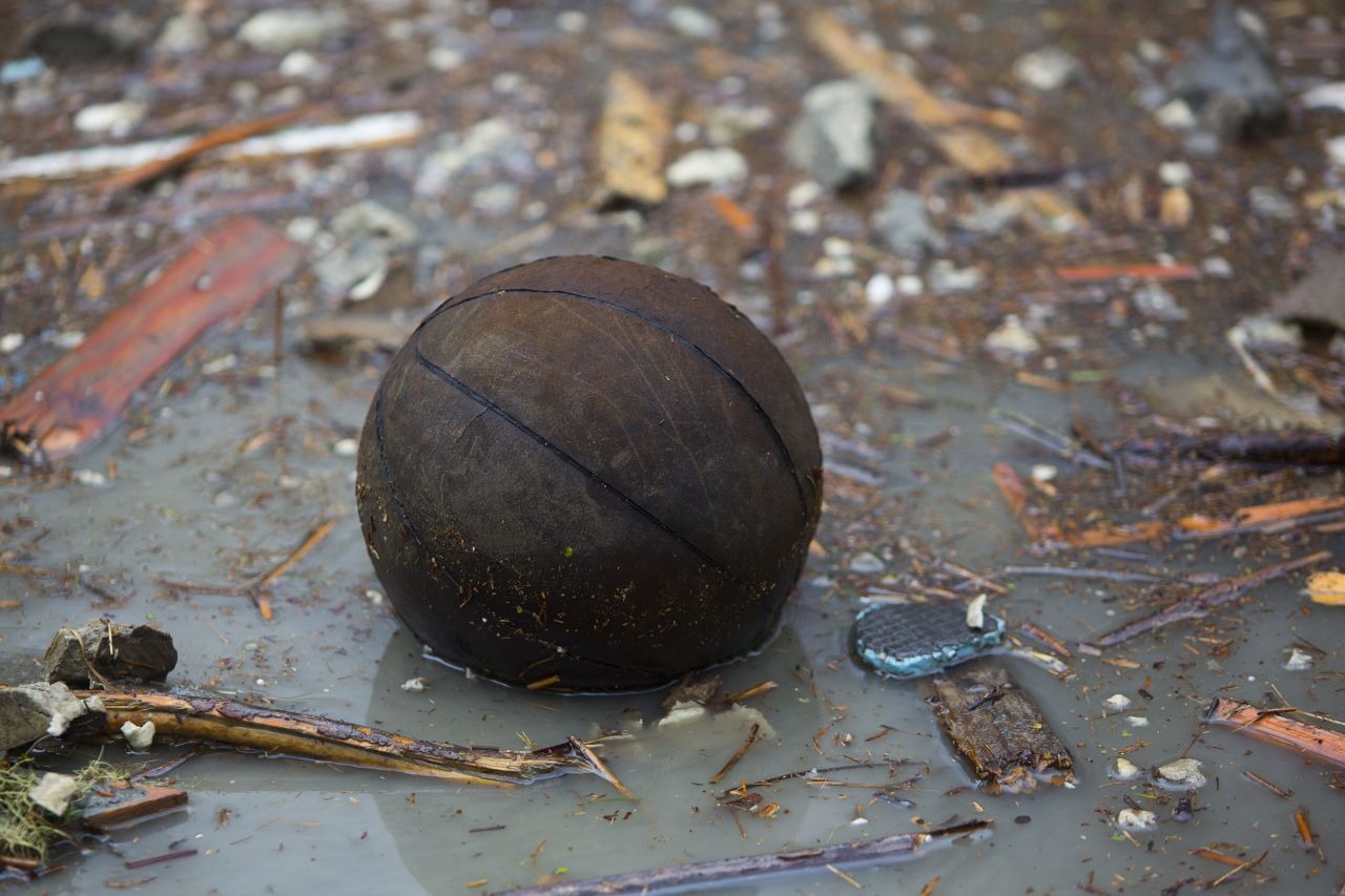 A basketball floats on floodwaters.