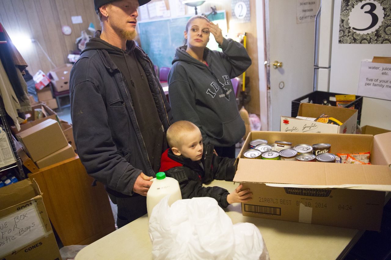 C.J. and Michelle Anderson, along with their 4-year-old son Cameron, pick up food from the Darrington Food Bank on Friday, March 28, at the First Baptist Church in Darrington. C.J.'s commute to the chicken farm where he works has gone from three minutes to three hours because of the closure of State Route 530, cutting down time with family and hurting them financially with increased fuel costs. 