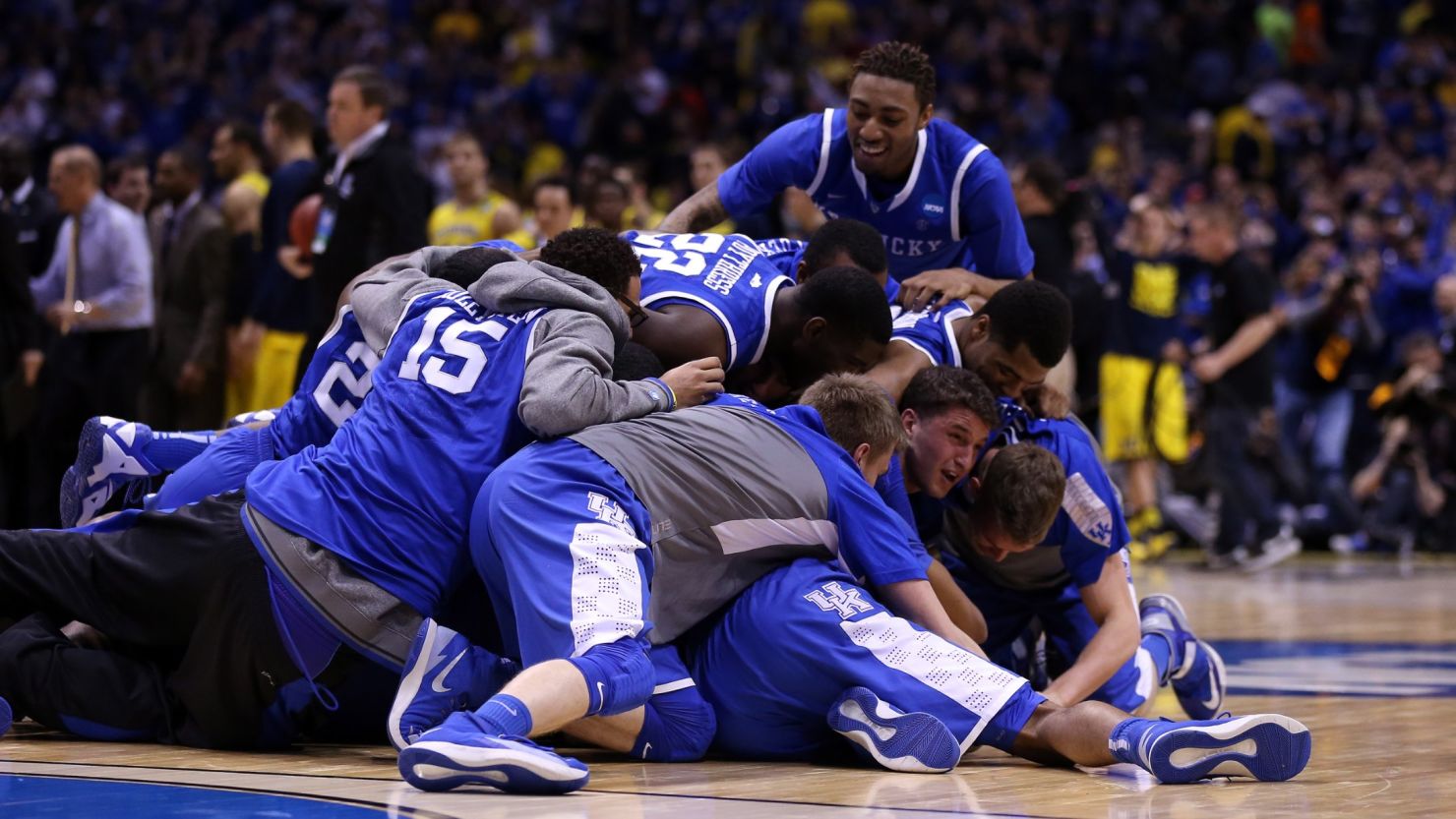 Kentucky, the No. 8 seed in its region, celebrates after freshman Aaron Harrison's late 3-pointer held up for the win.